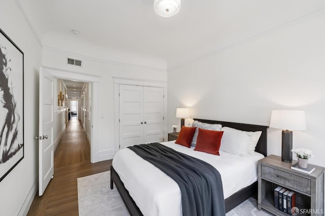 2427 Franklin St, San Francisco, CA 94123 - bedroom with wood finished floors, a closet, and crown molding