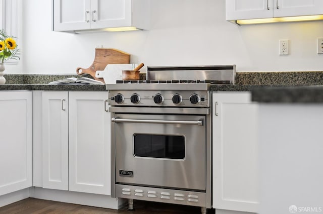 2427 Franklin St, San Francisco, CA 94123 - kitchen with designer range, dark countertops, white cabinetry, and dark wood finished floors