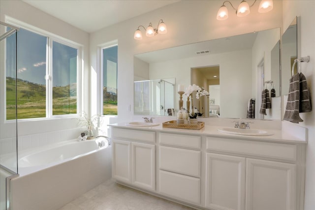 21051 Pinot Noir Dr, Patterson, CA 95363 - bathroom with a bath, a stall shower, double vanity, and tile patterned floors