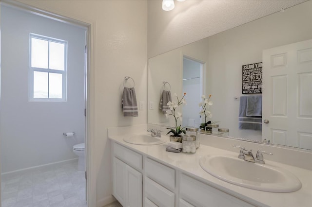 21051 Pinot Noir Dr, Patterson, CA 95363 - bathroom with double vanity, toilet, and tile patterned floors