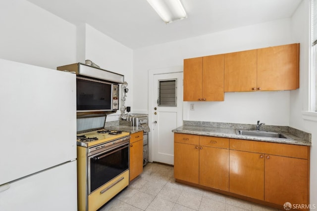 1915 Laguna St Unit 4, San Francisco, CA 94115 - kitchen with a sink, brown cabinets, and white appliances