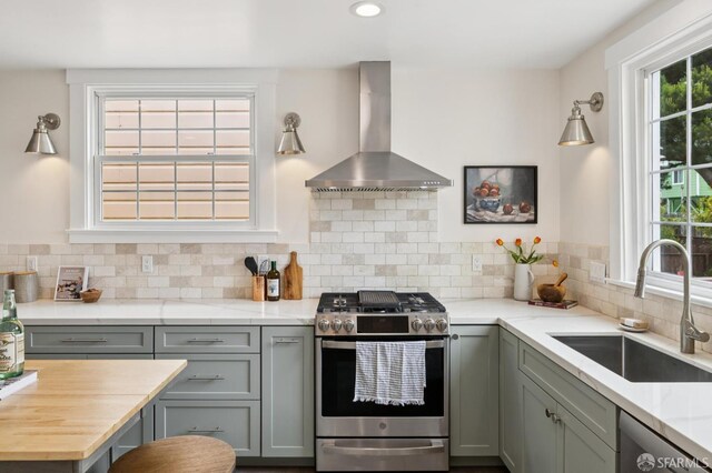 57 Theresa St, San Francisco, CA 94112 - kitchen with stainless steel appliances, wall chimney range hood, gray cabinets, tasteful backsplash, and recessed lighting