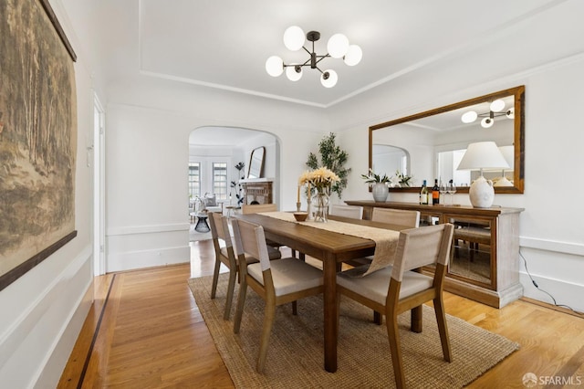 57 Theresa St, San Francisco, CA 94112 - dining area featuring arched walkways, a chandelier, and light wood-style floors