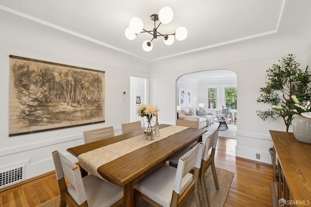 57 Theresa St, San Francisco, CA 94112 - dining space featuring arched walkways, a chandelier, and light wood finished floors