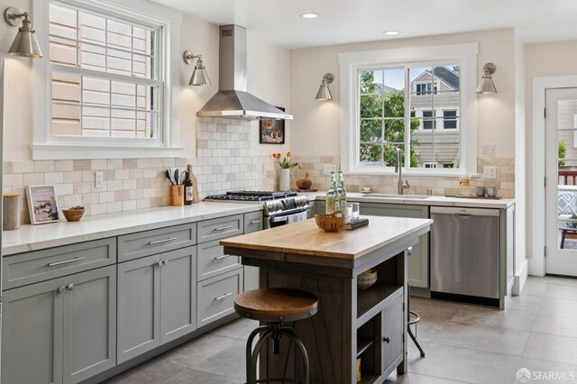 57 Theresa St, San Francisco, CA 94112 - kitchen featuring dishwasher, island range hood, gray cabinetry, butcher block countertops, and tasteful backsplash
