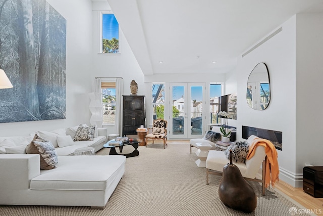 living room with french doors and a high ceiling