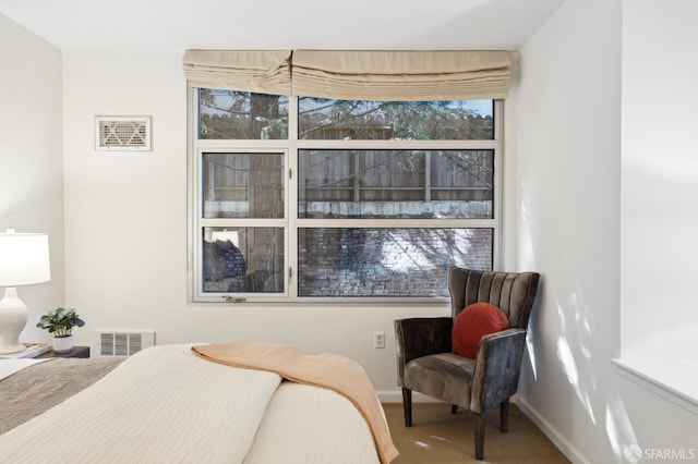 carpeted bedroom featuring baseboards and visible vents