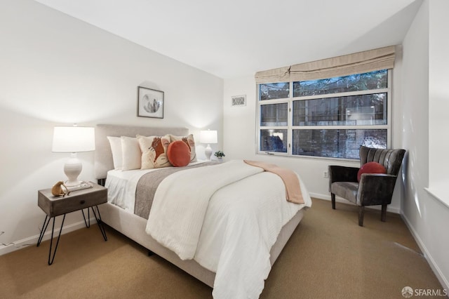 carpeted bedroom featuring baseboards and visible vents