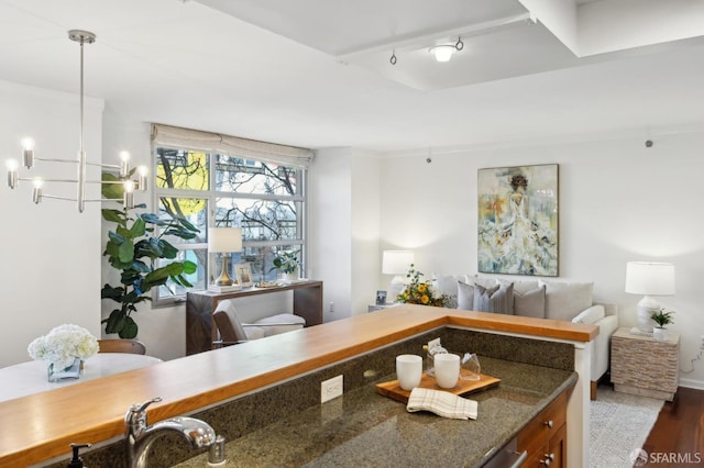 office area featuring a chandelier, dark wood-style flooring, and a sink