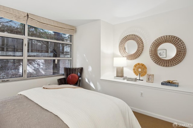 bedroom featuring carpet flooring and baseboards