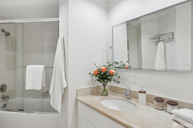 bathroom with combined bath / shower with glass door and vanity