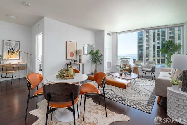 dining space featuring visible vents, baseboards, and wood finished floors