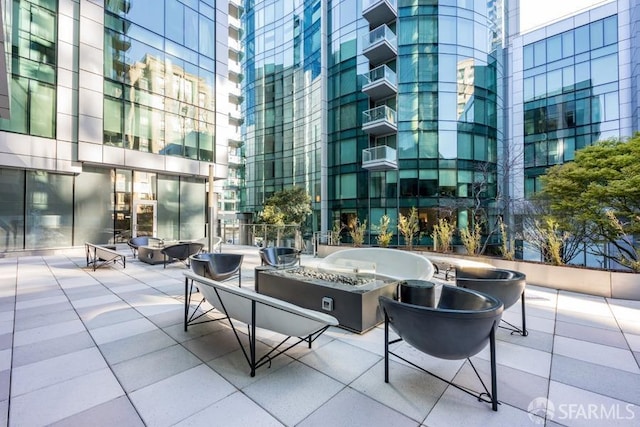 view of patio with cooling unit and a fire pit