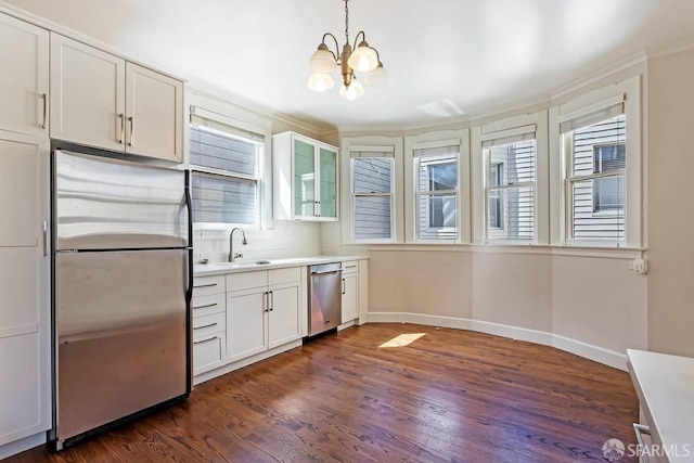 24 Magnolia St, San Francisco, CA 94123 - kitchen featuring appliances with stainless steel finishes, dark wood-type flooring, a sink, a chandelier, and light countertops