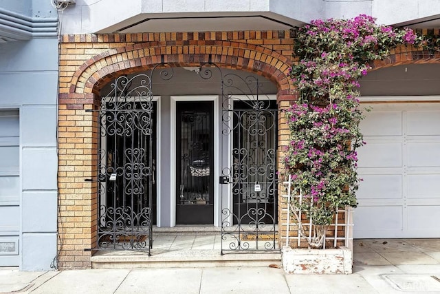24 Magnolia St, San Francisco, CA 94123 - view of exterior entry featuring a garage and brick siding