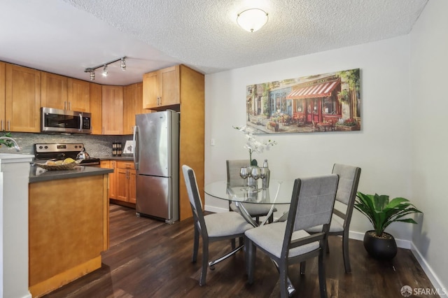 1140 Whipple Ave Unit 21, Redwood City, CA 94062 - kitchen with appliances with stainless steel finishes, dark wood-style floors, tasteful backsplash, a textured ceiling, and dark countertops