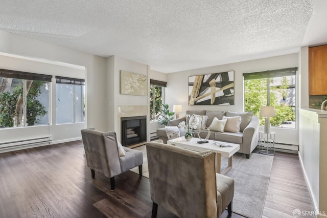 1140 Whipple Ave Unit 21, Redwood City, CA 94062 - living room featuring a baseboard heating unit, a fireplace, plenty of natural light, and a textured ceiling