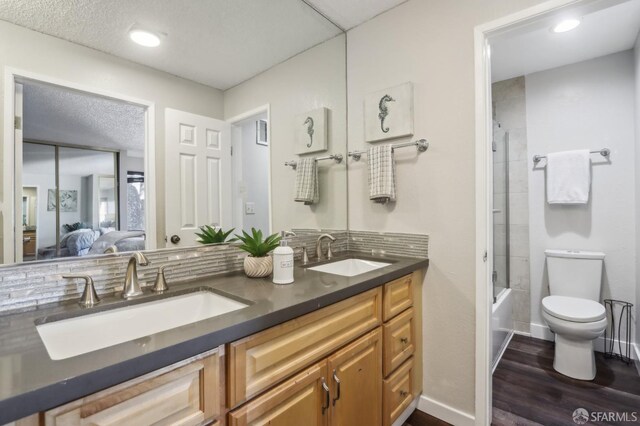 1140 Whipple Ave Unit 21, Redwood City, CA 94062 - bathroom featuring double vanity, toilet, connected bathroom, wood finished floors, and  shower combination