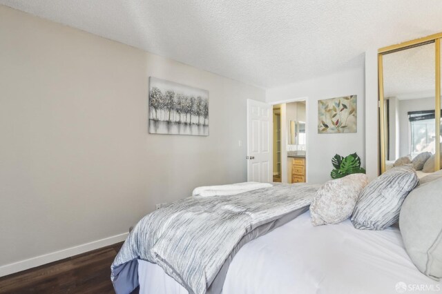 1140 Whipple Ave Unit 21, Redwood City, CA 94062 - bedroom featuring dark wood-style flooring, baseboards, a closet, and a textured ceiling