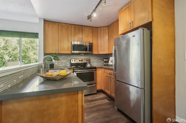 1140 Whipple Ave Unit 21, Redwood City, CA 94062 - kitchen with appliances with stainless steel finishes, dark countertops, tasteful backsplash, a sink, and dark wood-style flooring