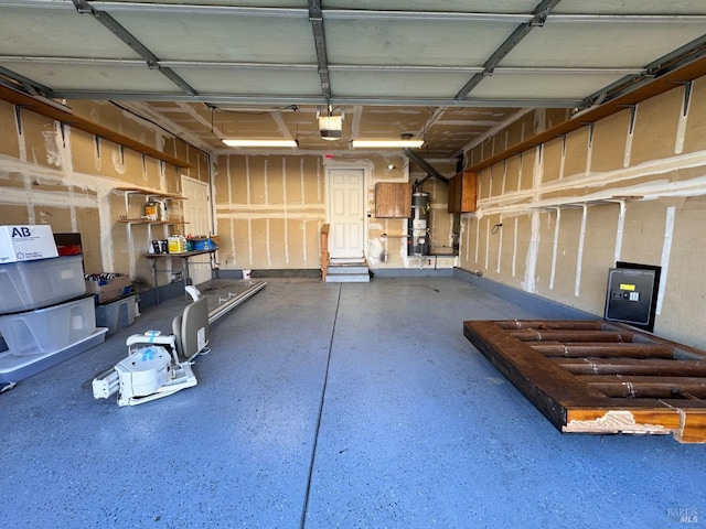 garage with a garage door opener and strapped water heater