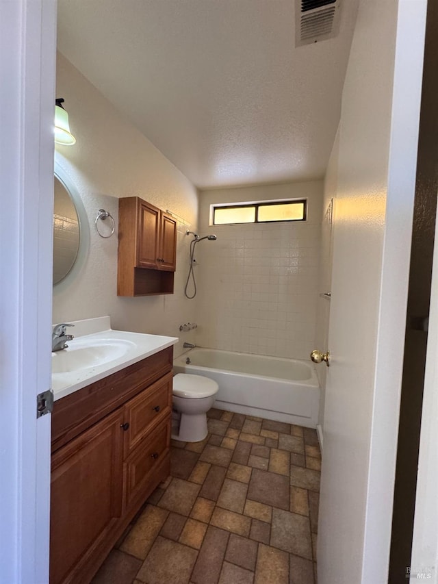 full bathroom with washtub / shower combination, vanity, and toilet