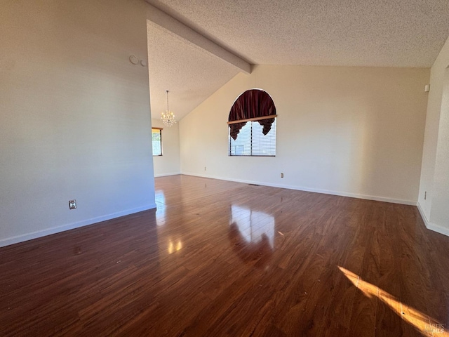 empty room with vaulted ceiling with beams, dark wood-type flooring, a chandelier, and a textured ceiling