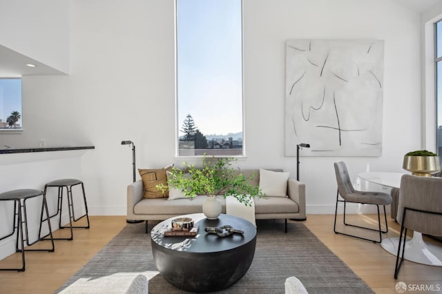 living room featuring bar area and light hardwood / wood-style floors