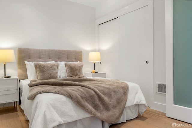 bedroom featuring a closet and light hardwood / wood-style flooring