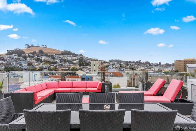 view of patio / terrace with a mountain view and an outdoor hangout area