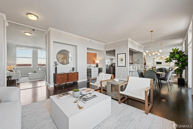 living room featuring hardwood / wood-style floors, a chandelier, and ornamental molding