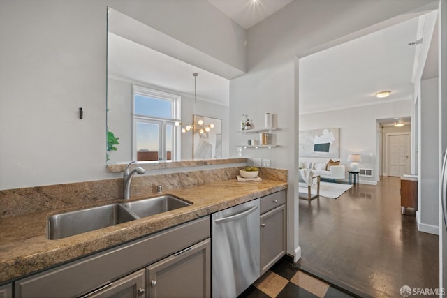 kitchen with pendant lighting, dishwasher, sink, light stone counters, and an inviting chandelier