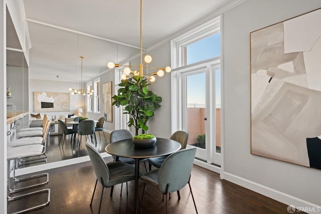 dining area with a chandelier, crown molding, and dark hardwood / wood-style floors