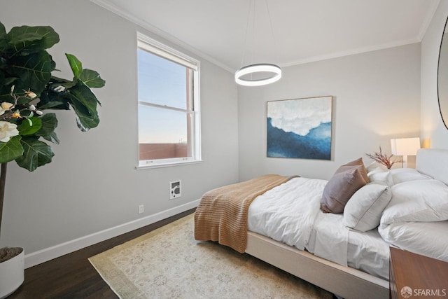 bedroom featuring multiple windows, dark hardwood / wood-style floors, and crown molding