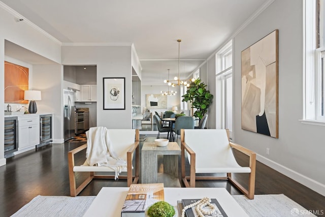 living room with wine cooler, a notable chandelier, and ornamental molding