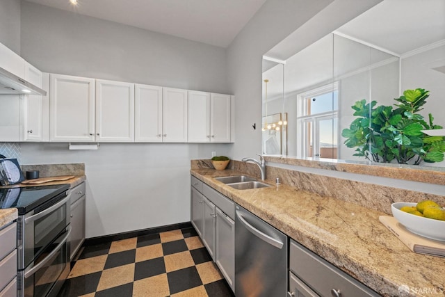 kitchen featuring sink, white cabinets, wall chimney range hood, and stainless steel appliances