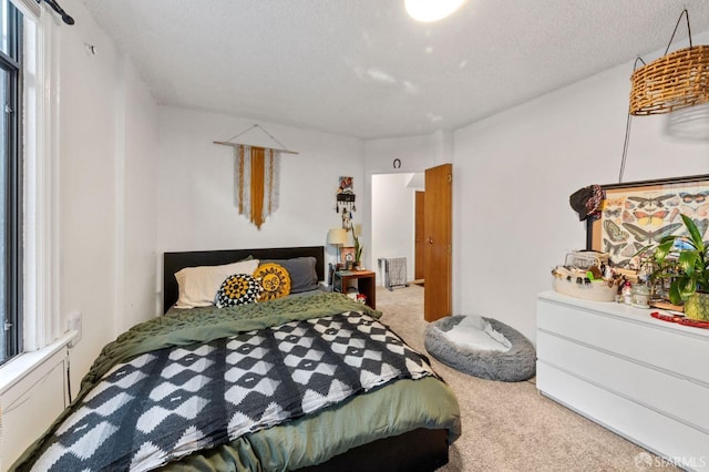 bedroom featuring a textured ceiling and carpet