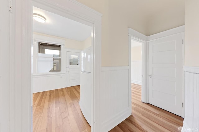 hall featuring wainscoting and light wood finished floors