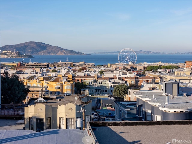 property's view of city featuring a water and mountain view