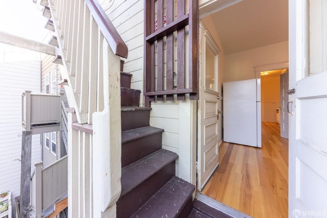 stairs featuring wood finished floors