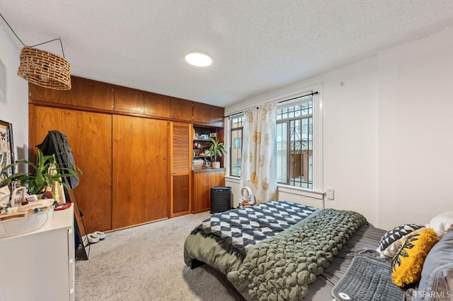 carpeted bedroom with a textured ceiling