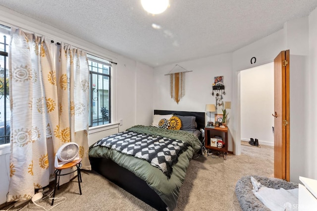 bedroom with carpet floors and a textured ceiling