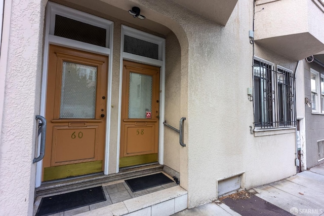 property entrance featuring stucco siding