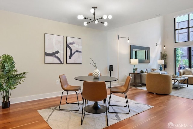 dining room with a notable chandelier, hardwood / wood-style floors, and a wealth of natural light