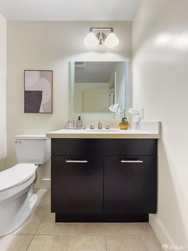 bathroom with tile patterned floors, vanity, and toilet