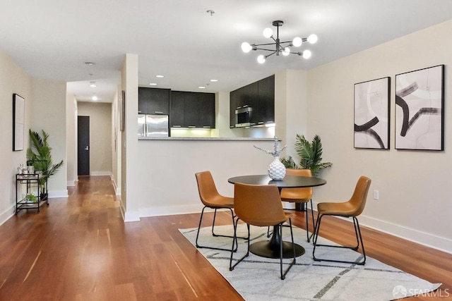 dining space with an inviting chandelier and dark wood-type flooring