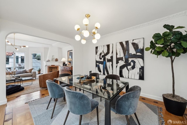 dining area featuring wood-type flooring and a chandelier