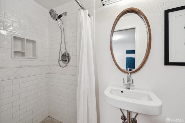 bathroom with sink and a shower with curtain