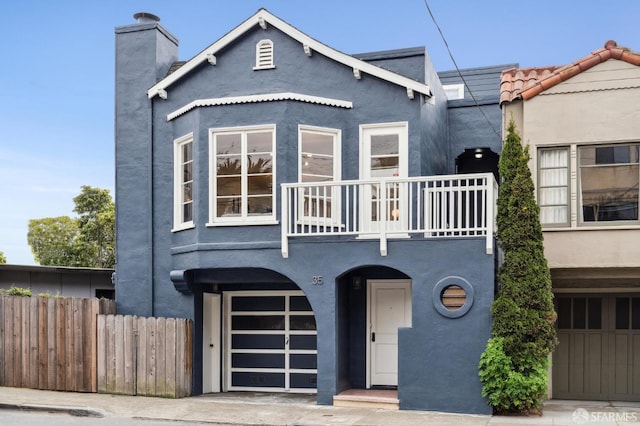 view of front of home with a garage and a balcony