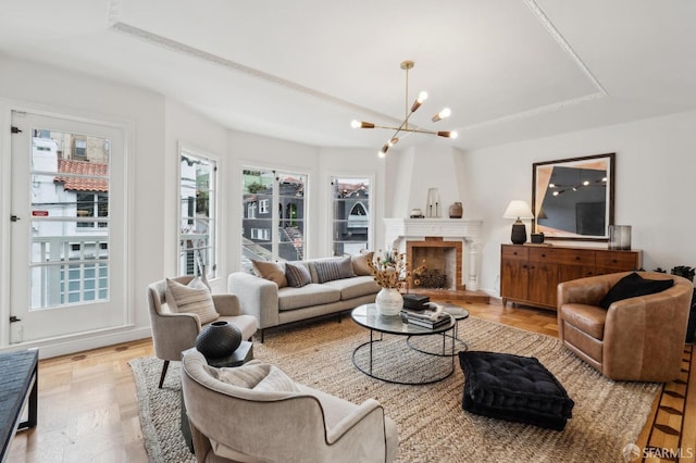 living room with an inviting chandelier and a tray ceiling